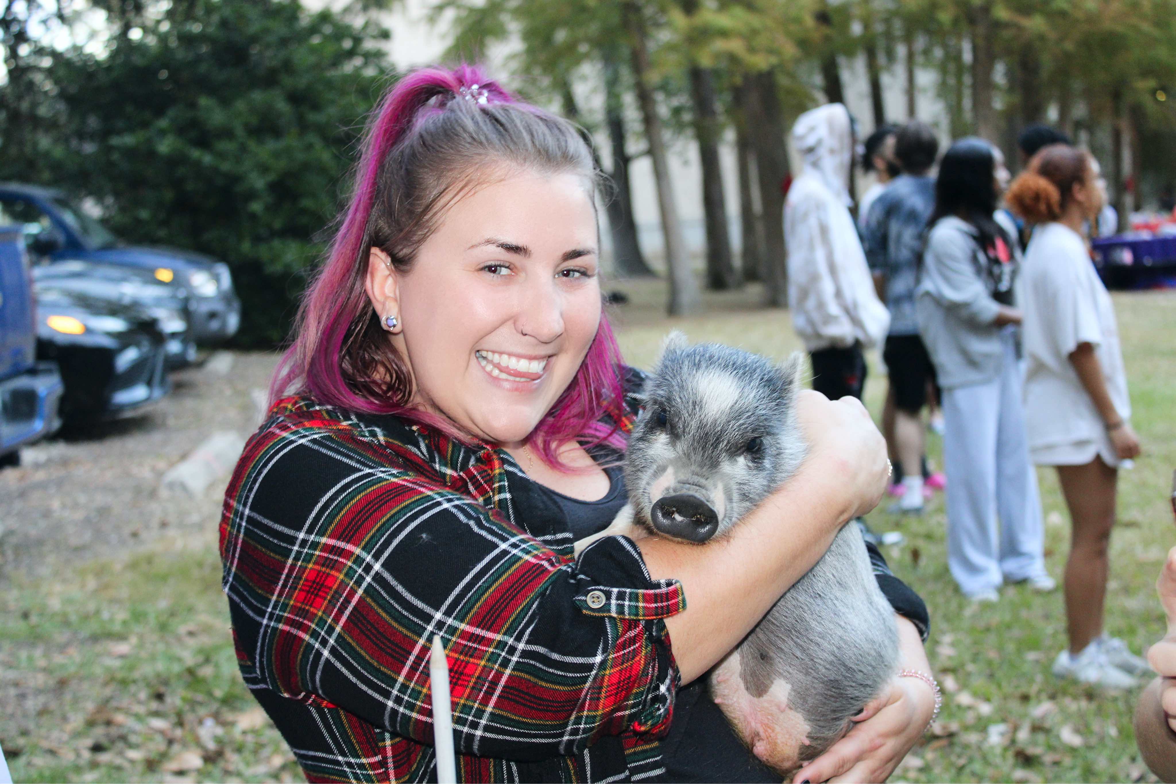 student holding a pig