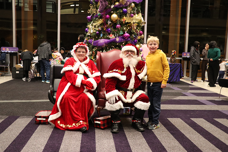 child with Santa and Mrs. Claus